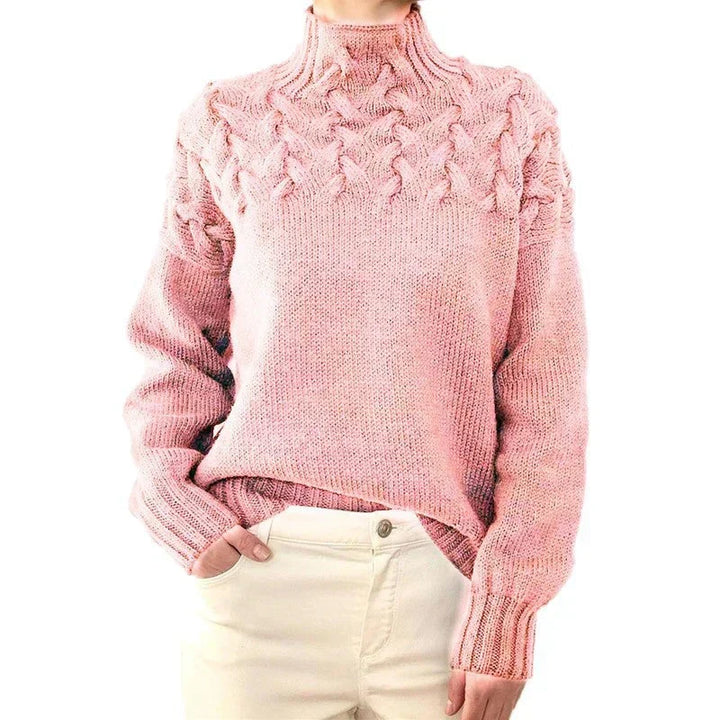 Model wearing the light pink cable knit sweater with a mock neck and twisted cable yoke