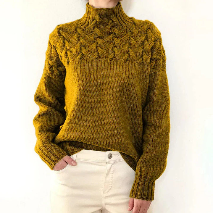 Model wearing the mustard cable knit sweater with a mock neck and twisted cable yoke