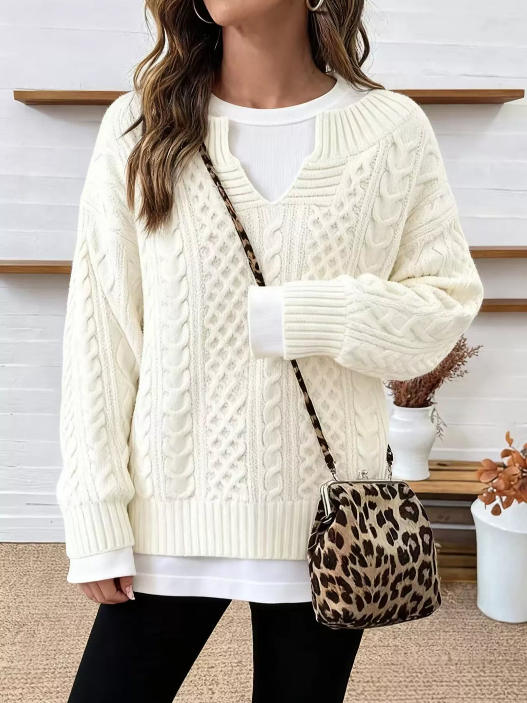 Off-white oversized cable knit v neck sweater styled with a crossbody bag