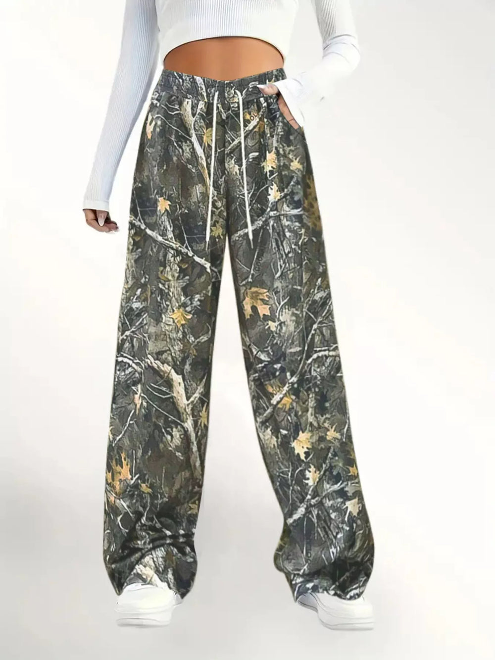 Camo wide leg pants with drawstring waist, front view with a white long sleeve top