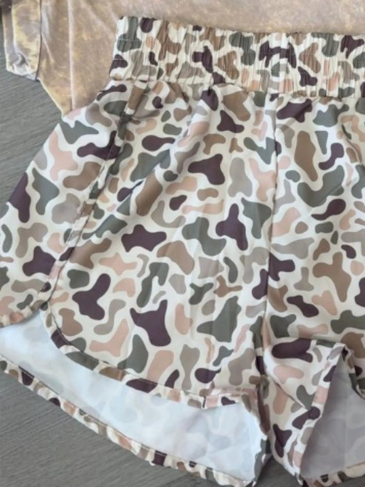 Beige camo high waisted shorts with tulip hem laid flat