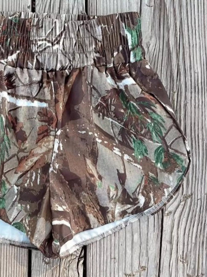 Forest camo shorts close-up of the high waist and curved hem