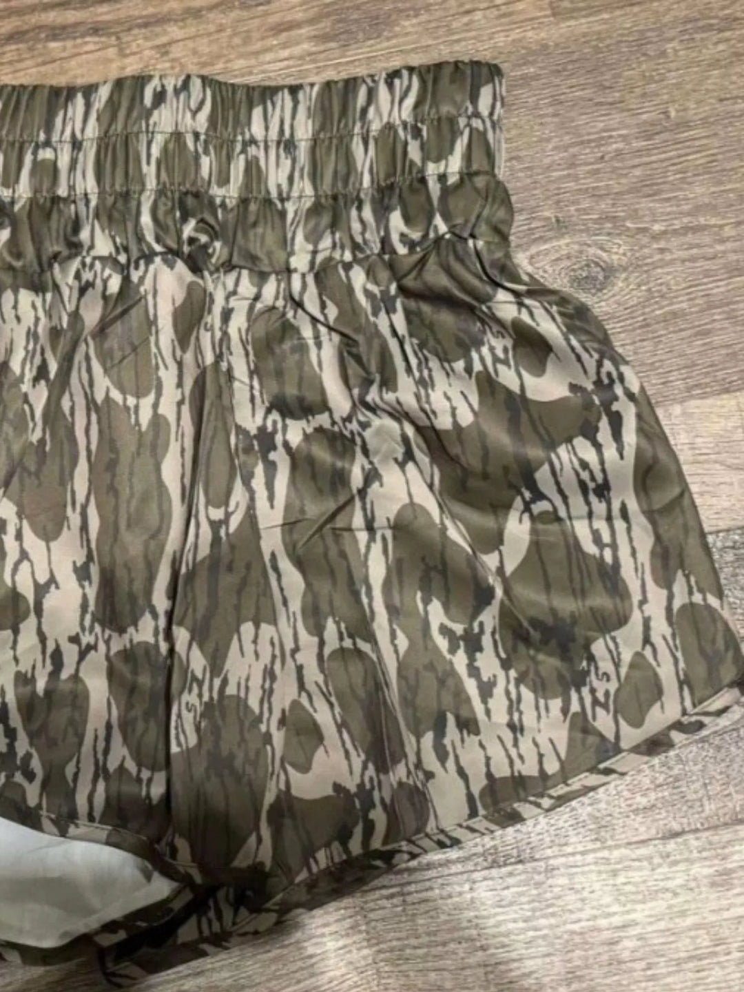 Olive camo shorts close-up of smocked waistband and pattern