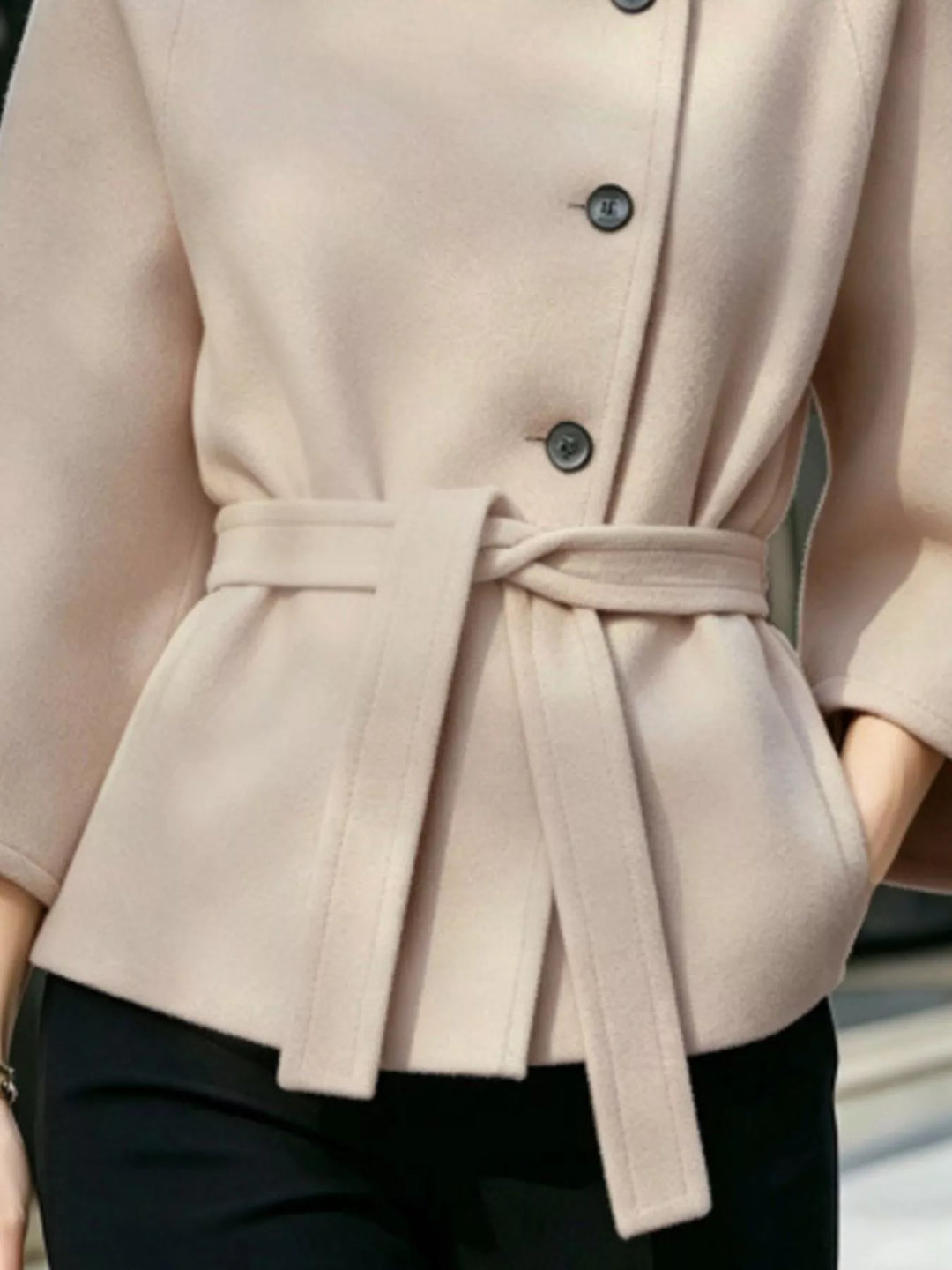 Asymmetric button tie belt stand collar in beige, close-up detail