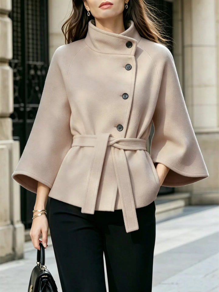 Asymmetric button tie belt stand collar in beige, front view