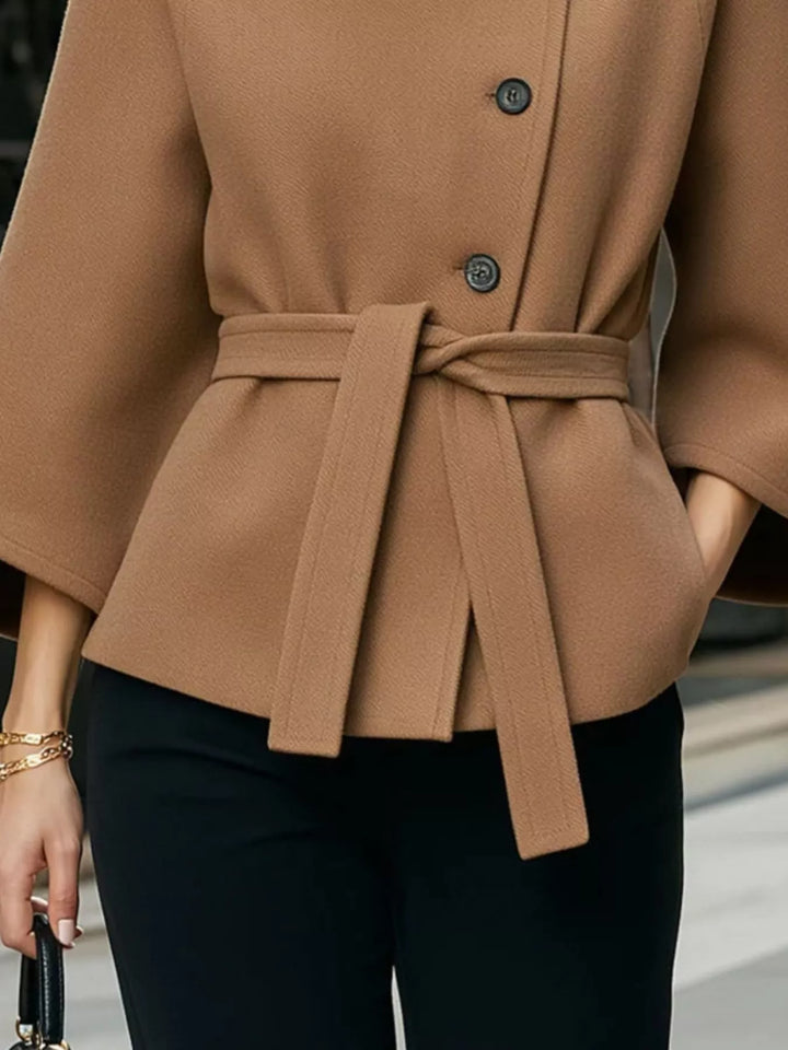 Asymmetric button tie belt stand collar in caramel, close-up detail