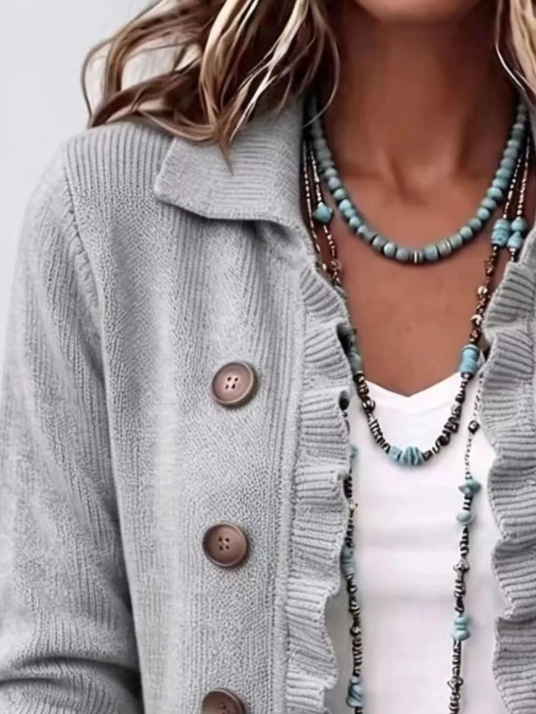 Light gray collared cardigan close-up of the ruffle edge and buttons