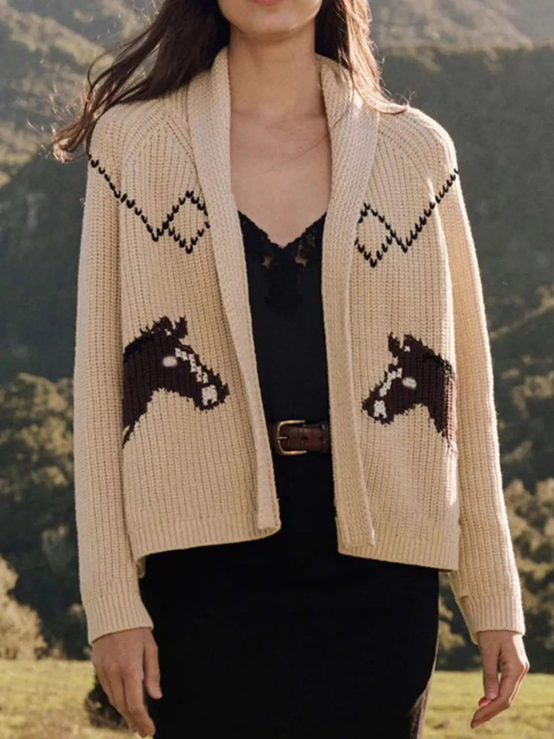 Cream chunky knit shawl collar cardigan with horse head motifs, open front