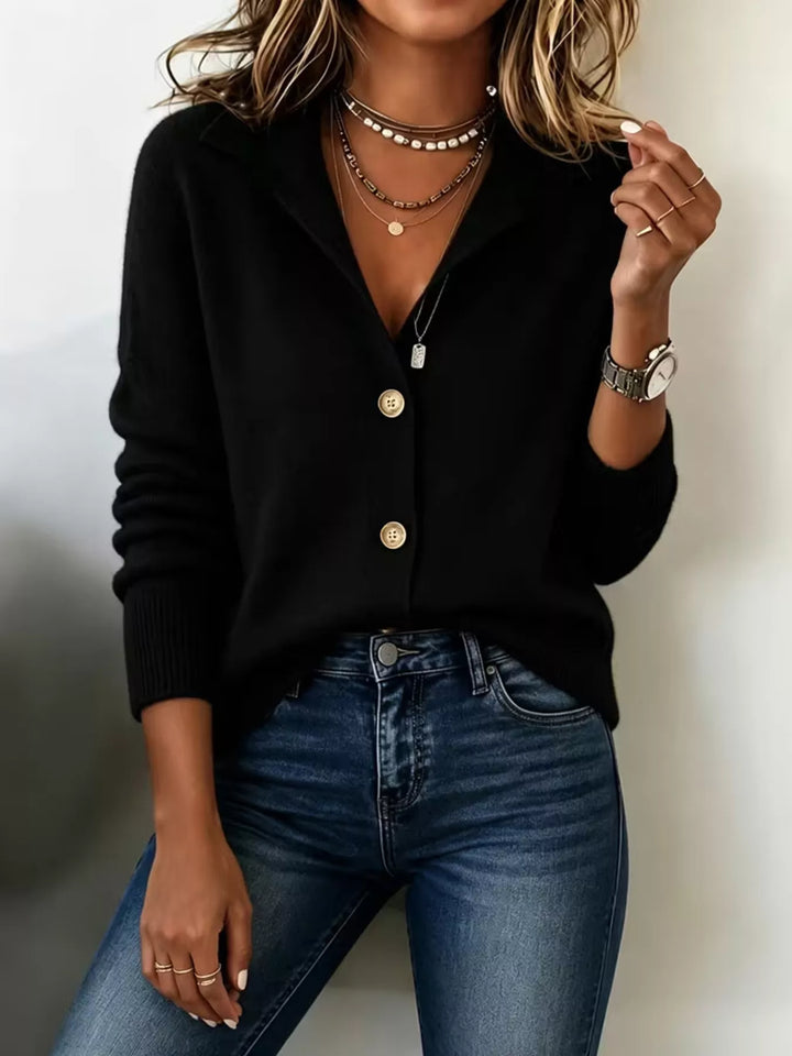 Black collared V neck cardigan with button front, styled with jeans