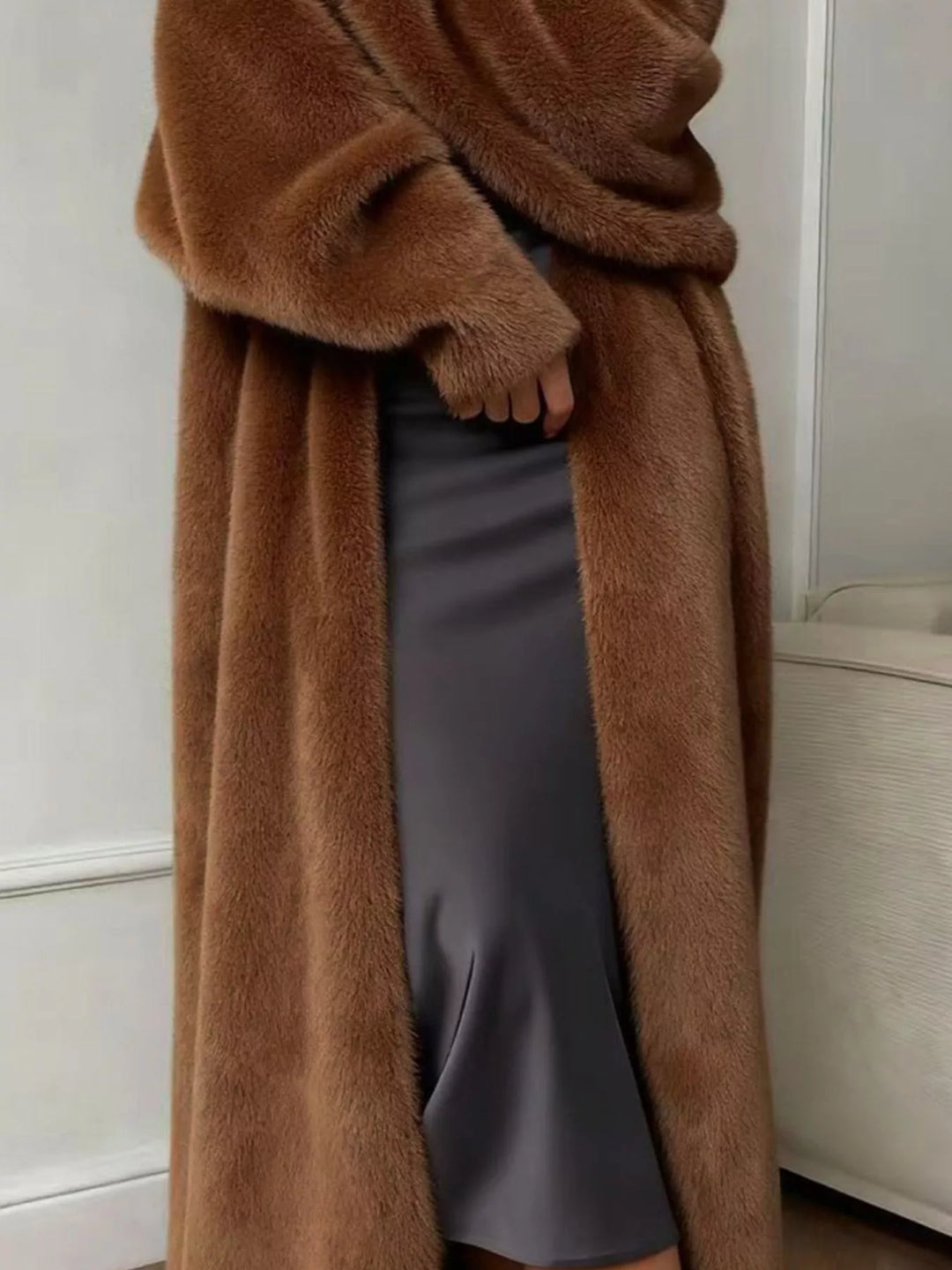 Chocolate longline fuzzy cardigan open front falling over a gray satin dress