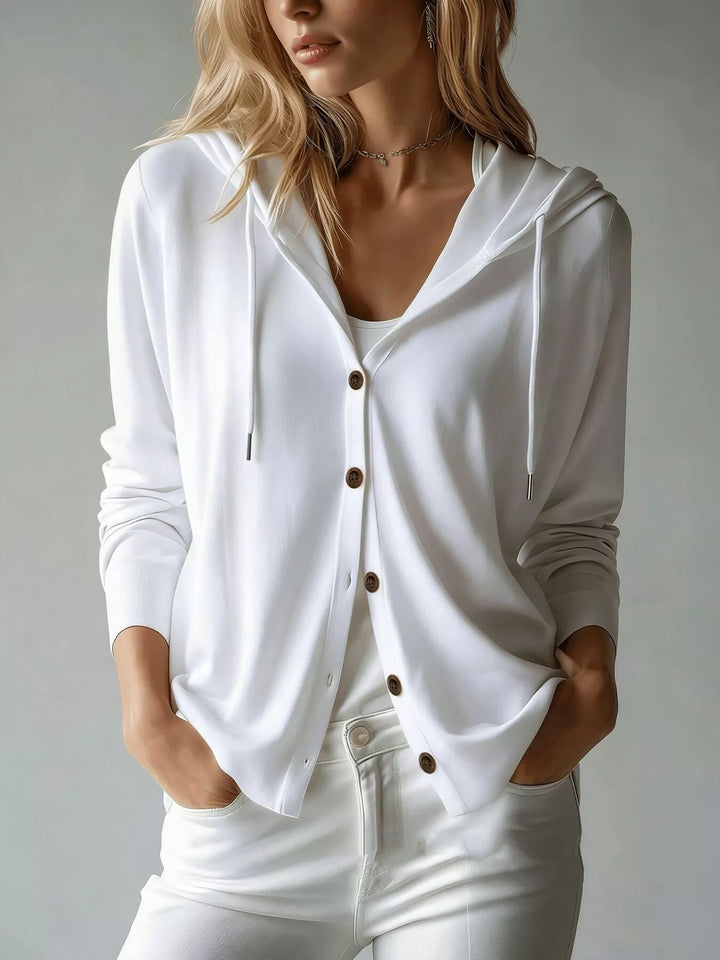 White hooded button front cardigan with V neck, styled with white pants