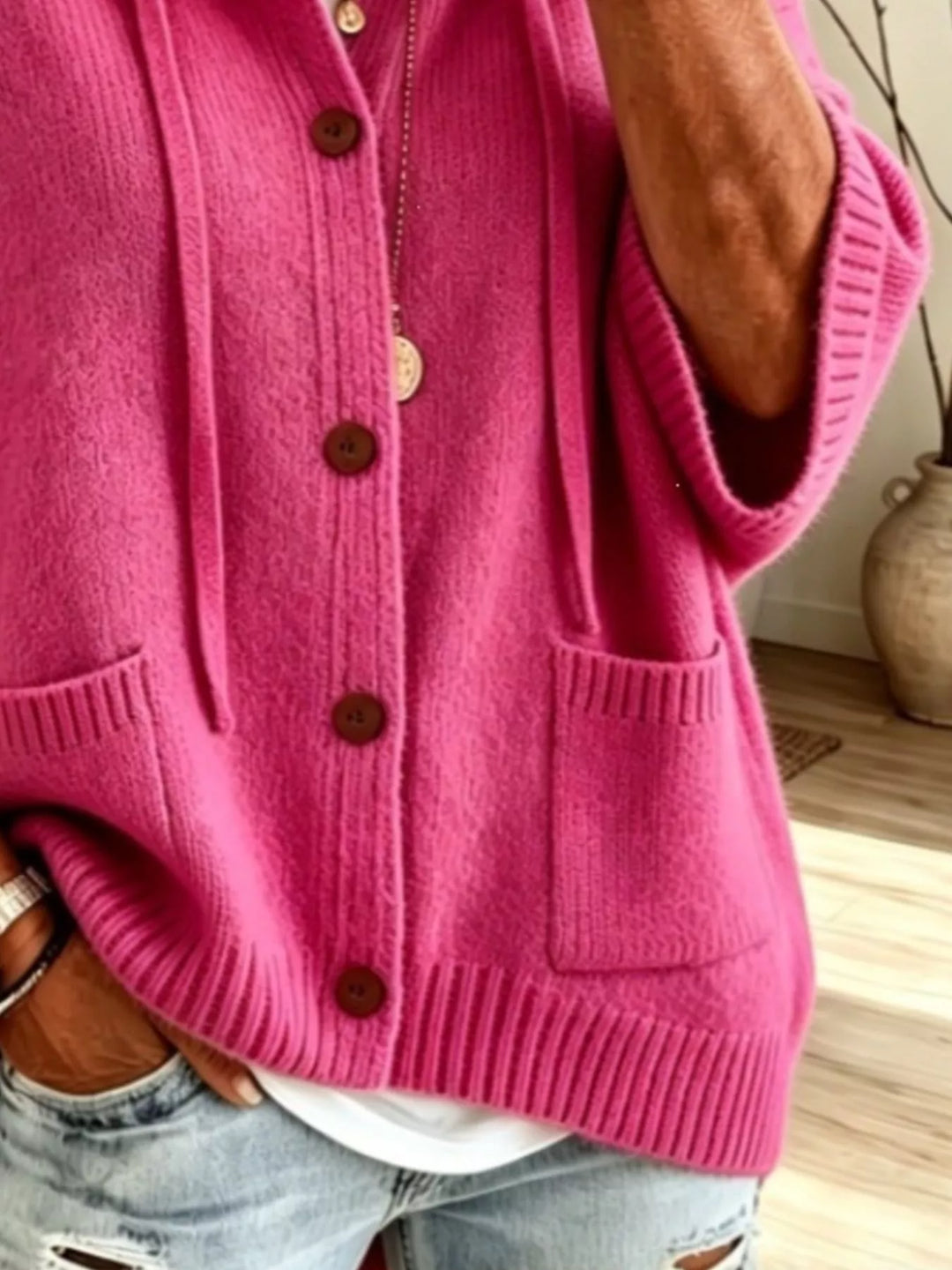 Fuchsia hooded cardigan close-up of the patch pocket and ribbed hem