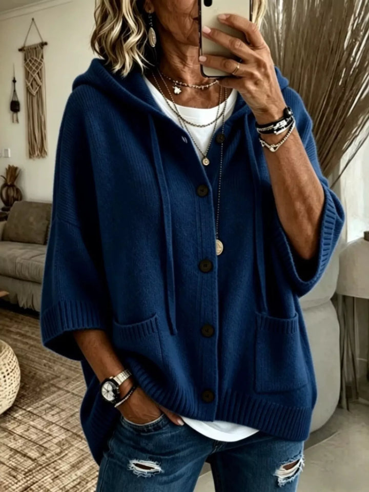Navy hooded button front cardigan with batwing sleeves, worn with ripped jeans
