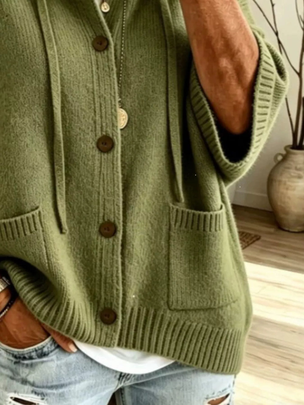 Olive green hooded cardigan close-up of the patch pocket and ribbed hem
