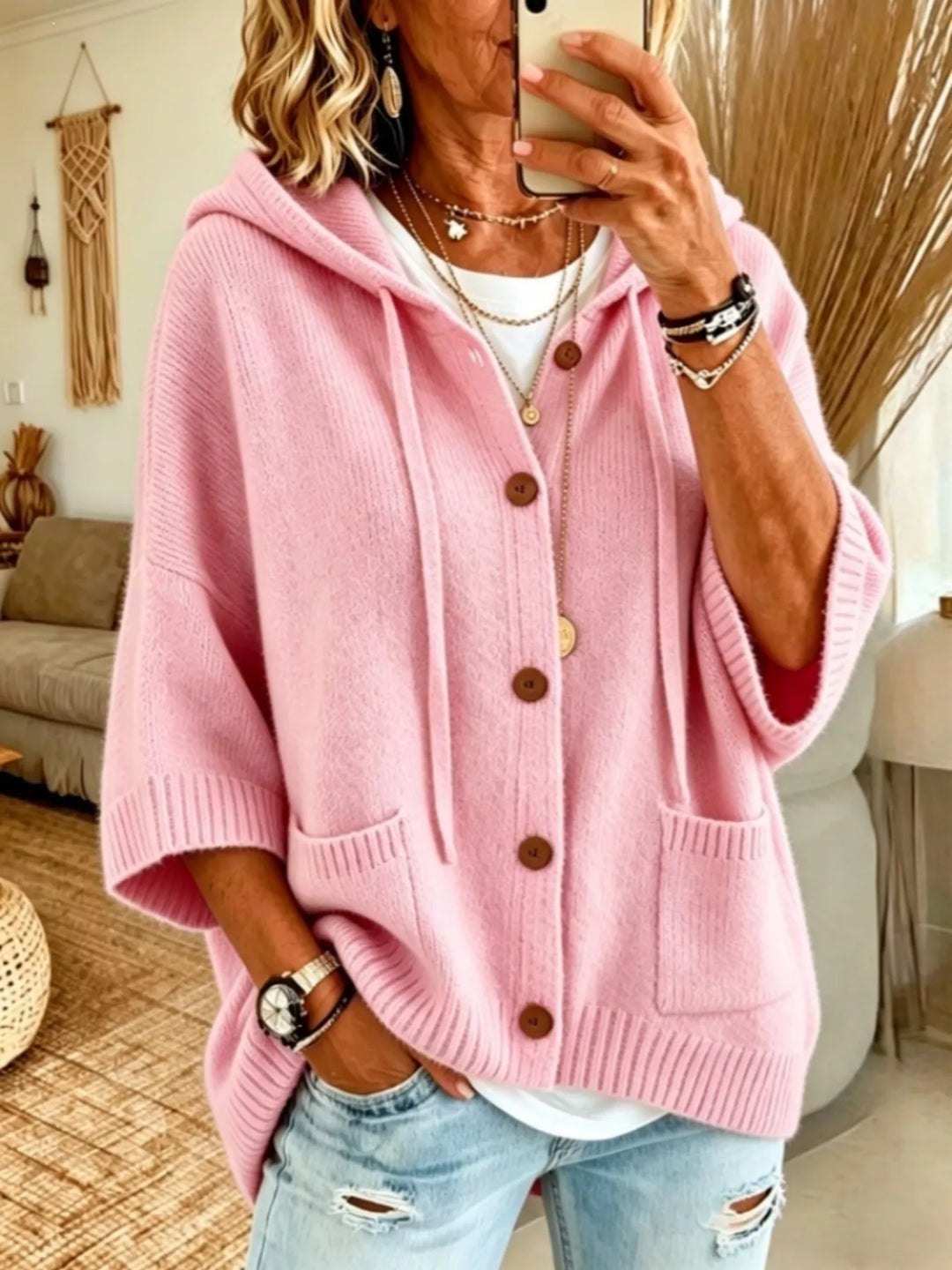 Pink hooded button front cardigan with batwing sleeves, styled with jeans