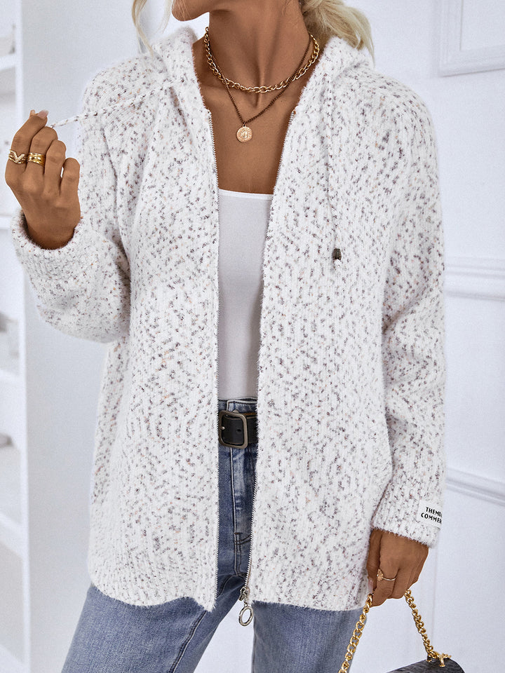 White hooded cardigan worn open with a handbag, front view