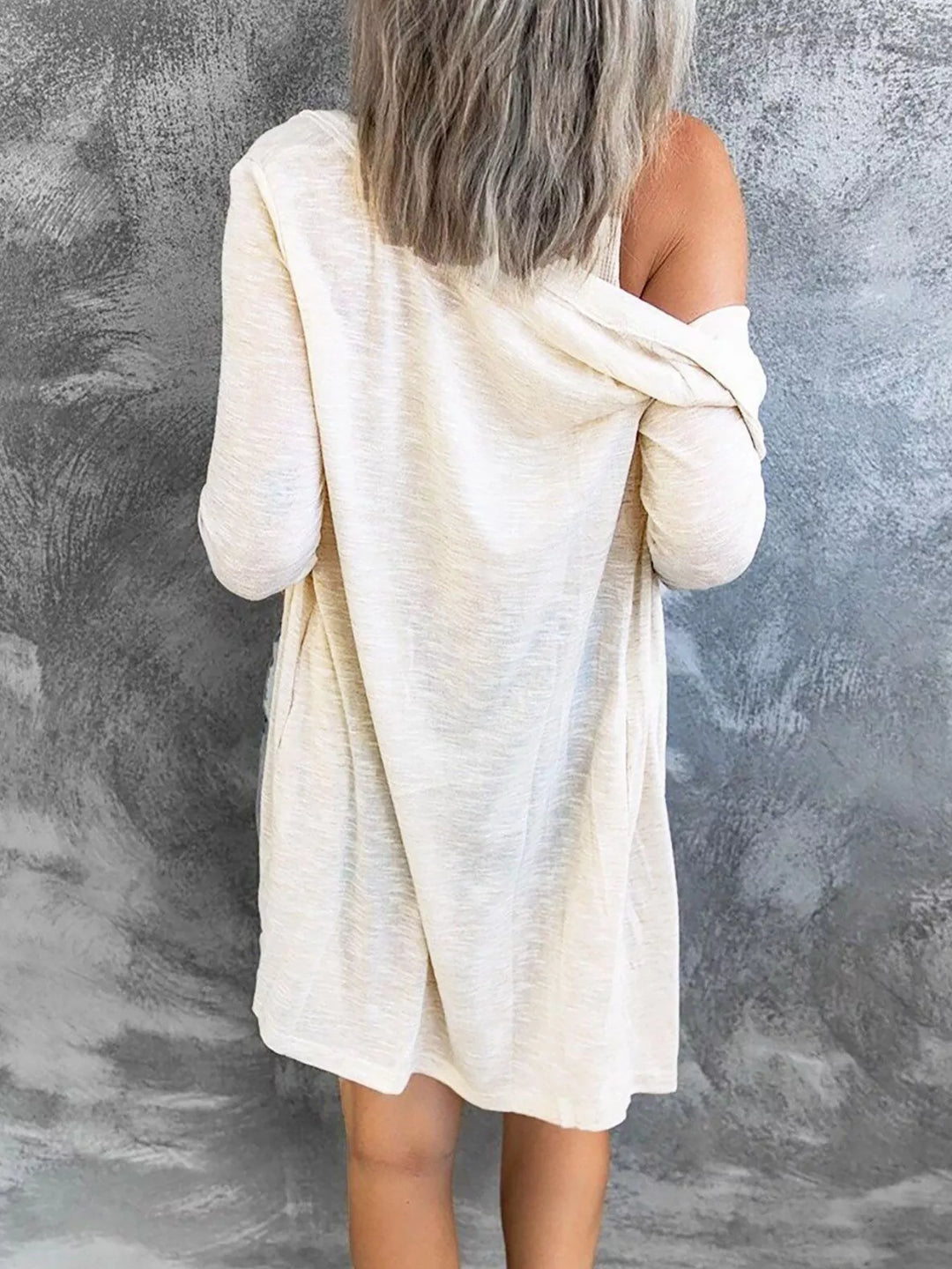 Back view of white longline cardigan draped off the shoulder