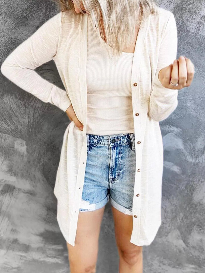 Women's cardigan in white, lightweight longline button front, worn with denim shorts