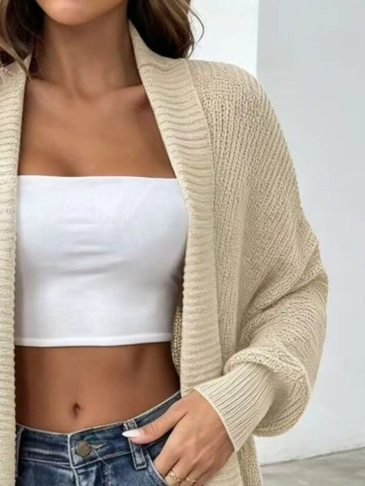 Close-up of the oatmeal ribbed cardigan over a white top and jeans