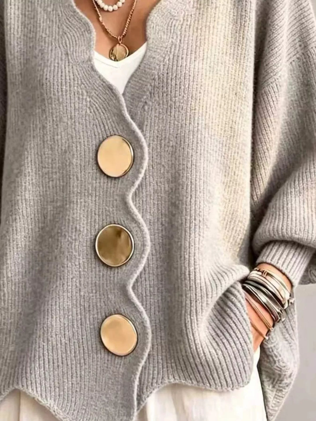 Light gray cardigan button front and scalloped hem, hand in pocket detail
