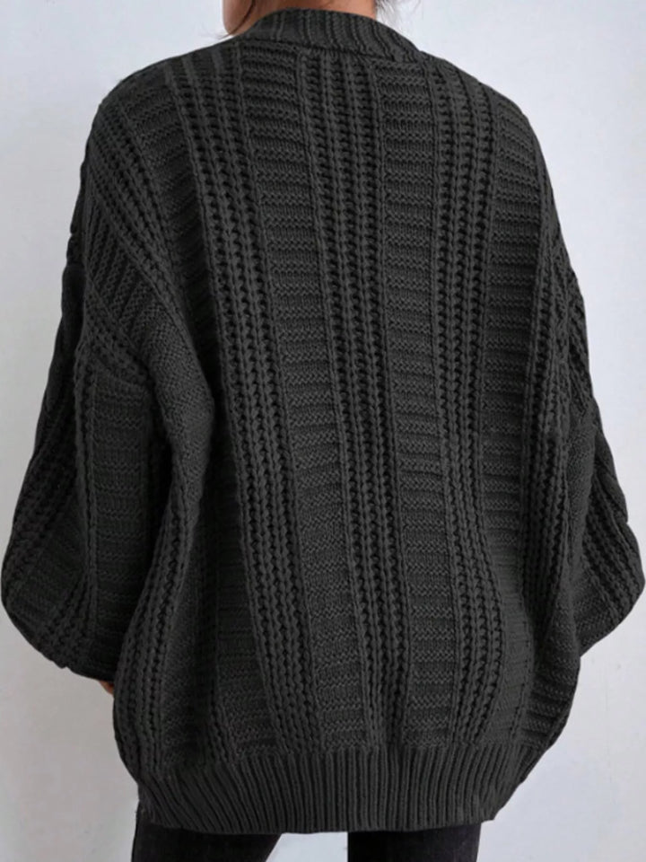 Chunky cable knit button front v-neck in black, back view