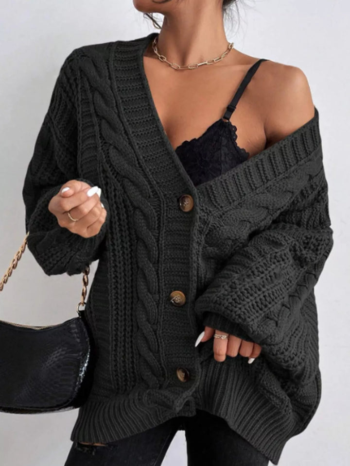 Chunky cable knit button front v-neck in black, styled on model