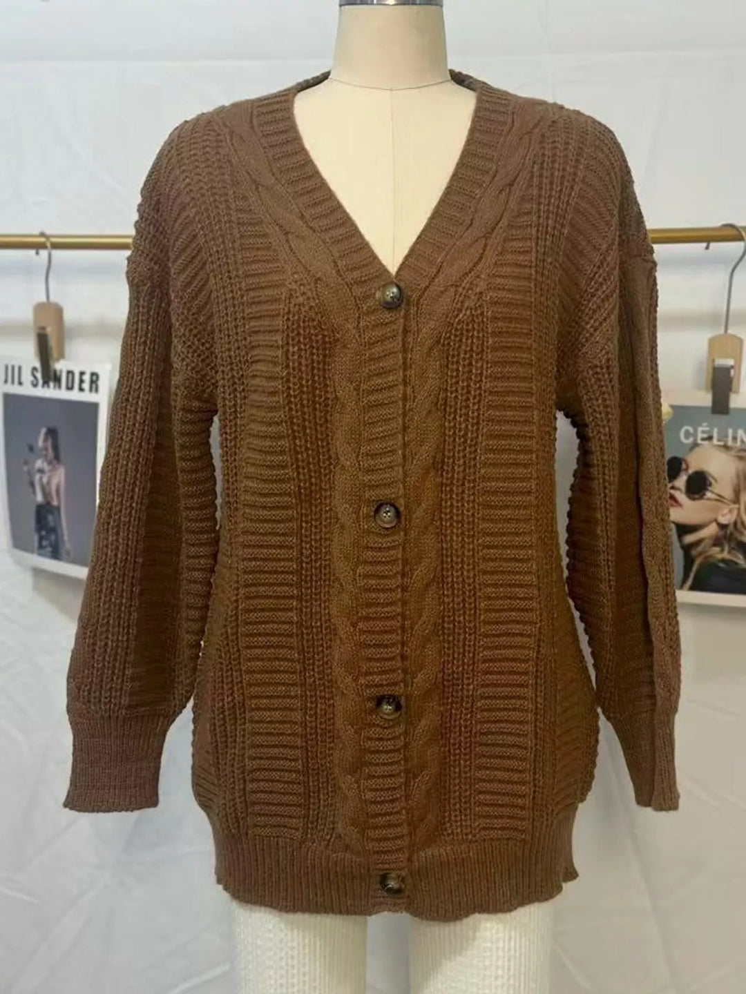 Chunky cable knit button front v-neck in dark brown, flat lay
