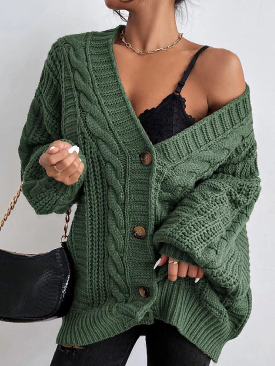 Chunky cable knit button front v-neck in green, styled on model