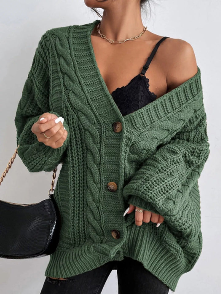 Chunky cable knit button front v-neck in green, styled on model
