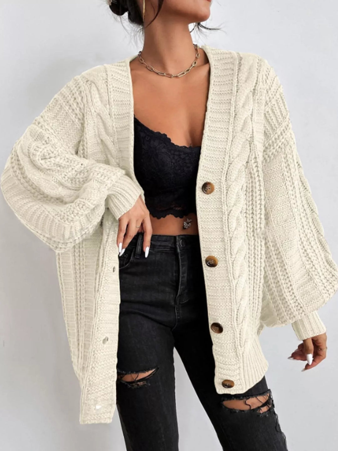 Chunky cable knit button front v-neck in off-white, styled on model