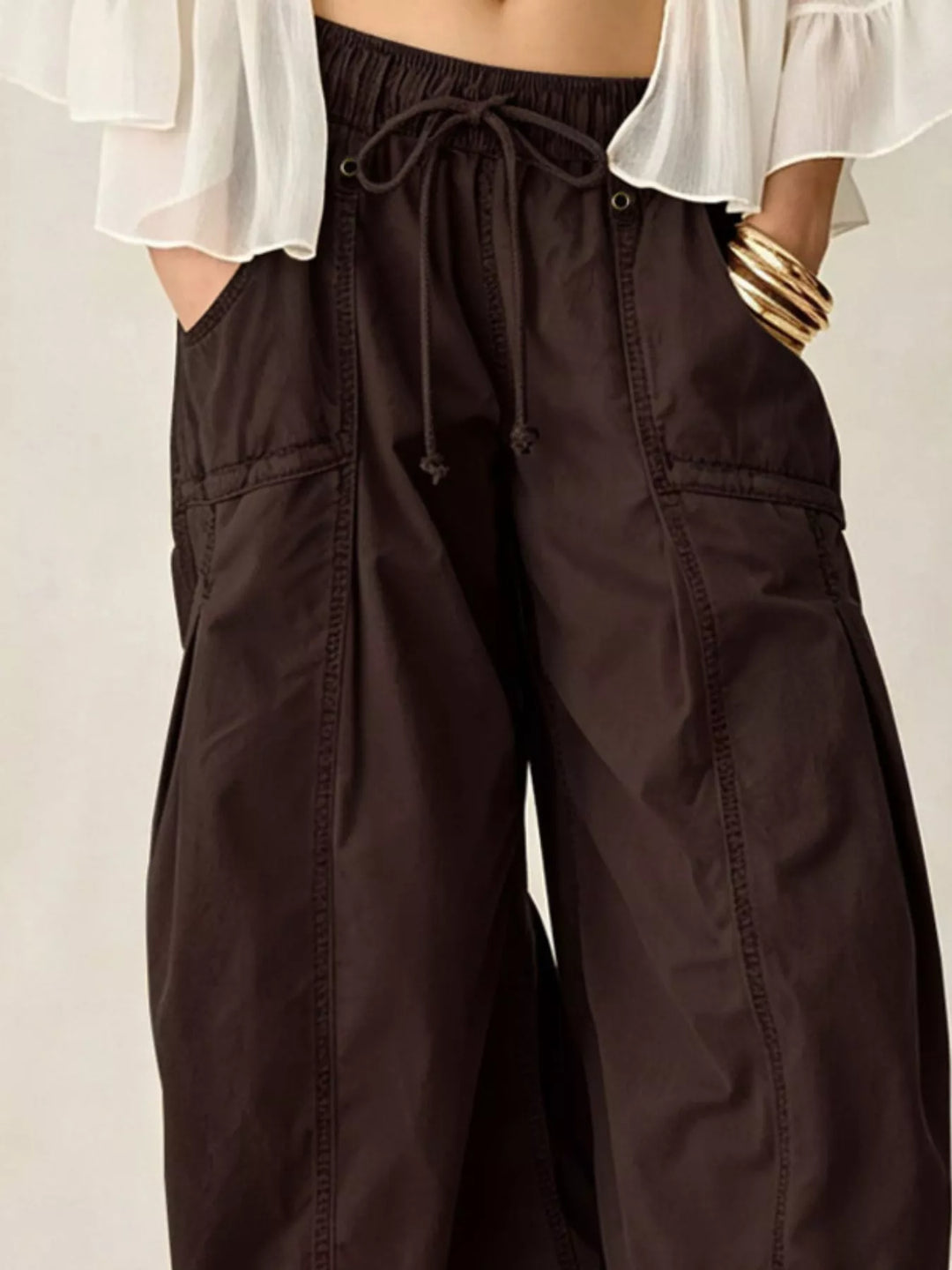 Close-up of espresso cargo pants with large pocket and drawstring waist