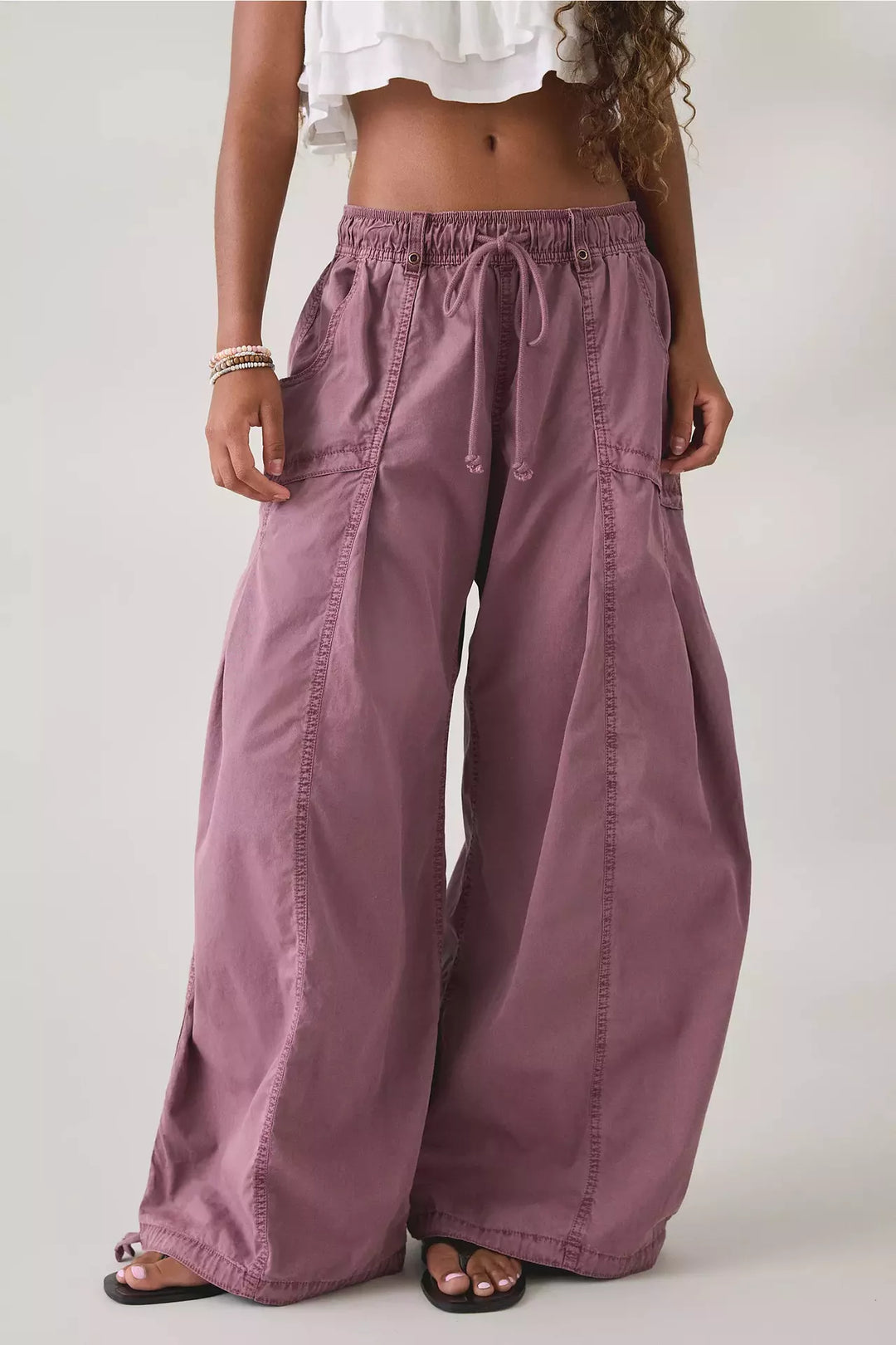 Mauve wide leg parachute cargo pants with drawstring waist, front view