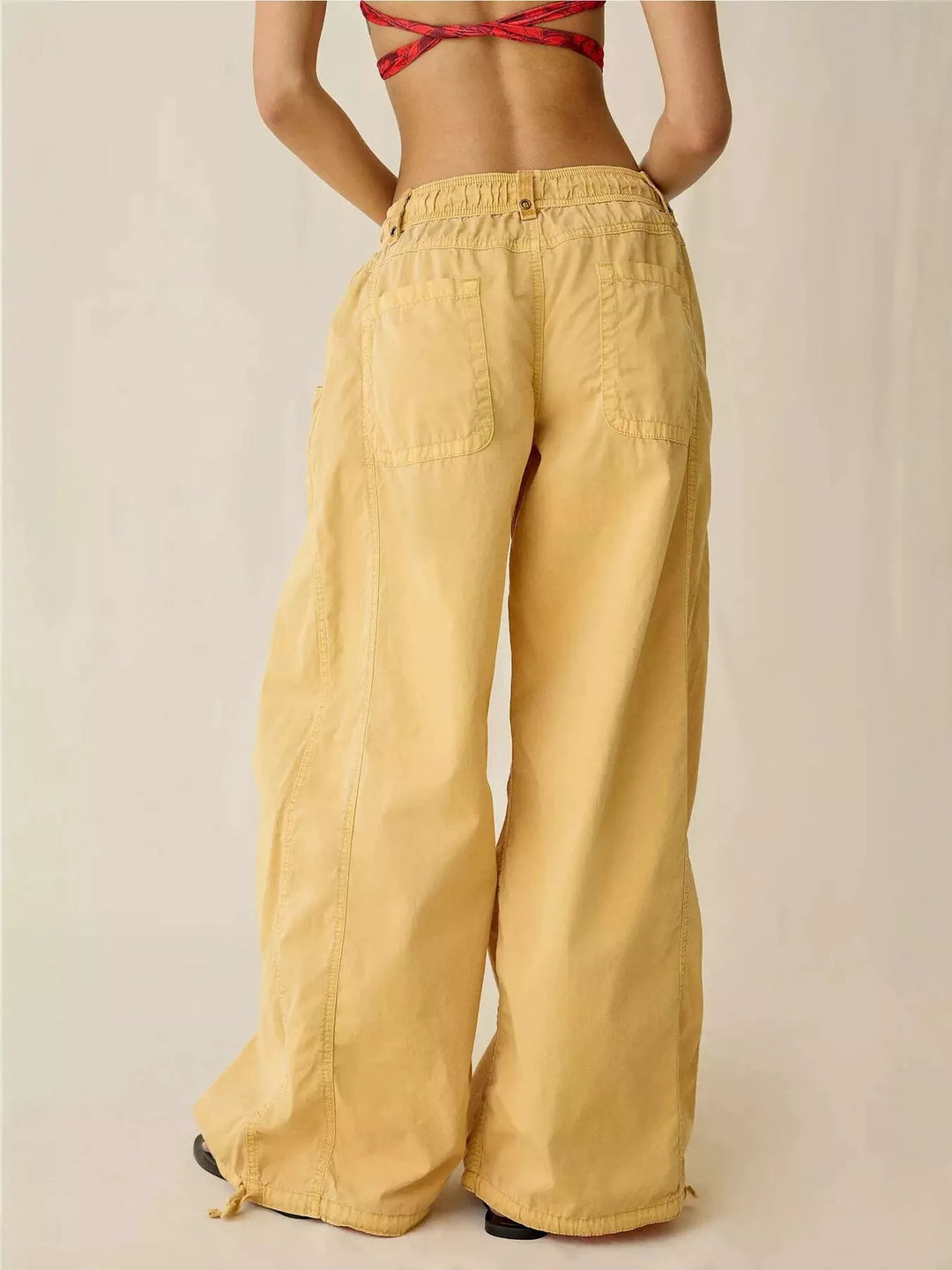Back view of the mustard wide leg parachute cargo pants