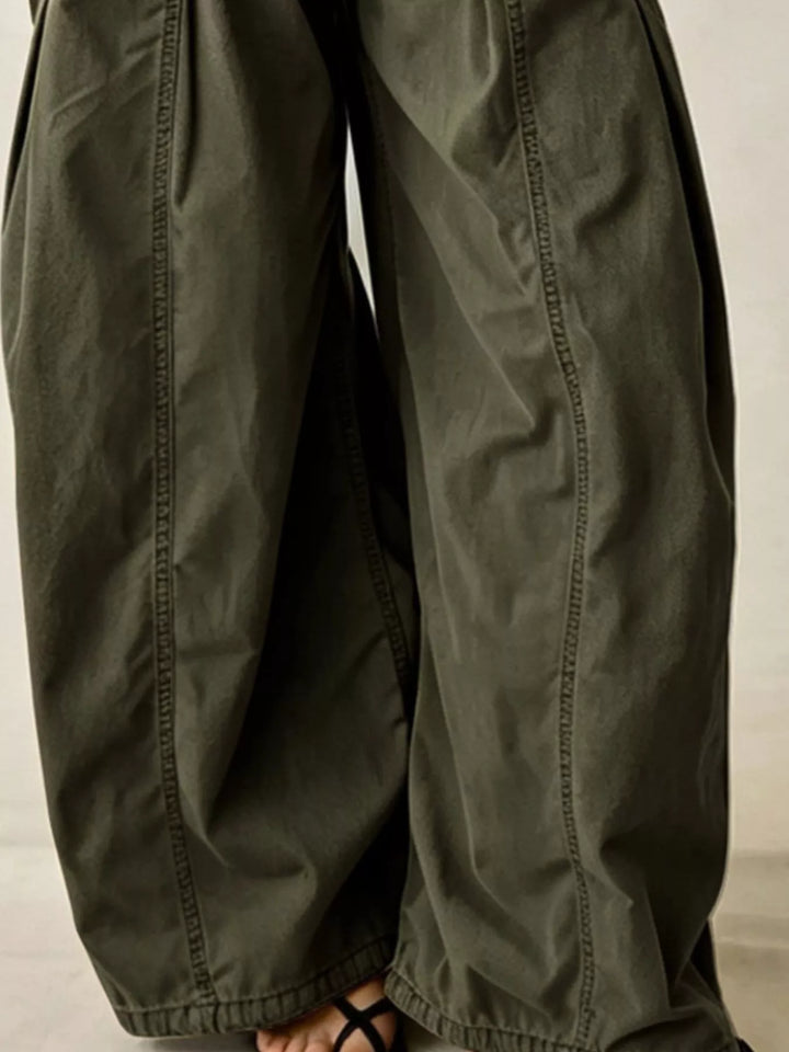 Close-up of olive parachute cargo pants wide legs and sandals