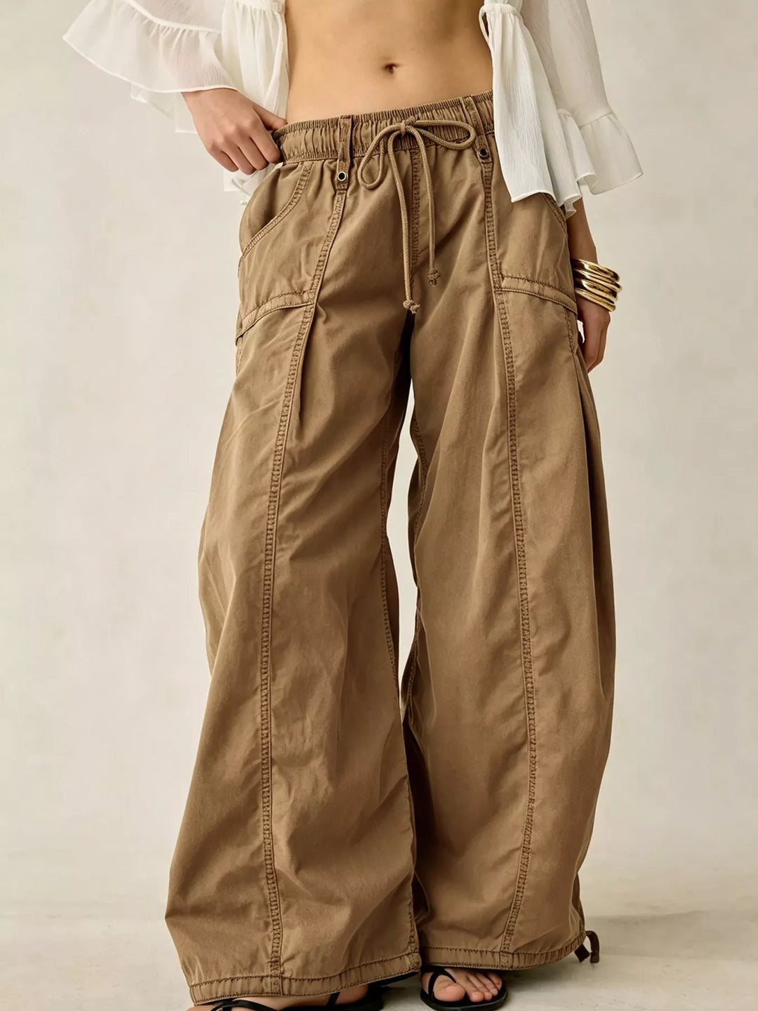 Tan wide leg parachute cargo pants with drawstring waist, front view