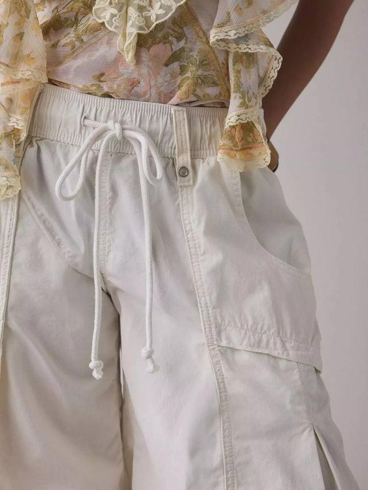 Close-up of white cargo pants waistband and drawstring