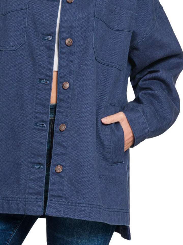Close-up of the navy shacket showing chest pockets, buttons and side slit hem