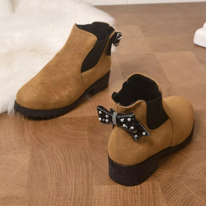 Tan block heel Chelsea boots shown on a wooden floor, side view