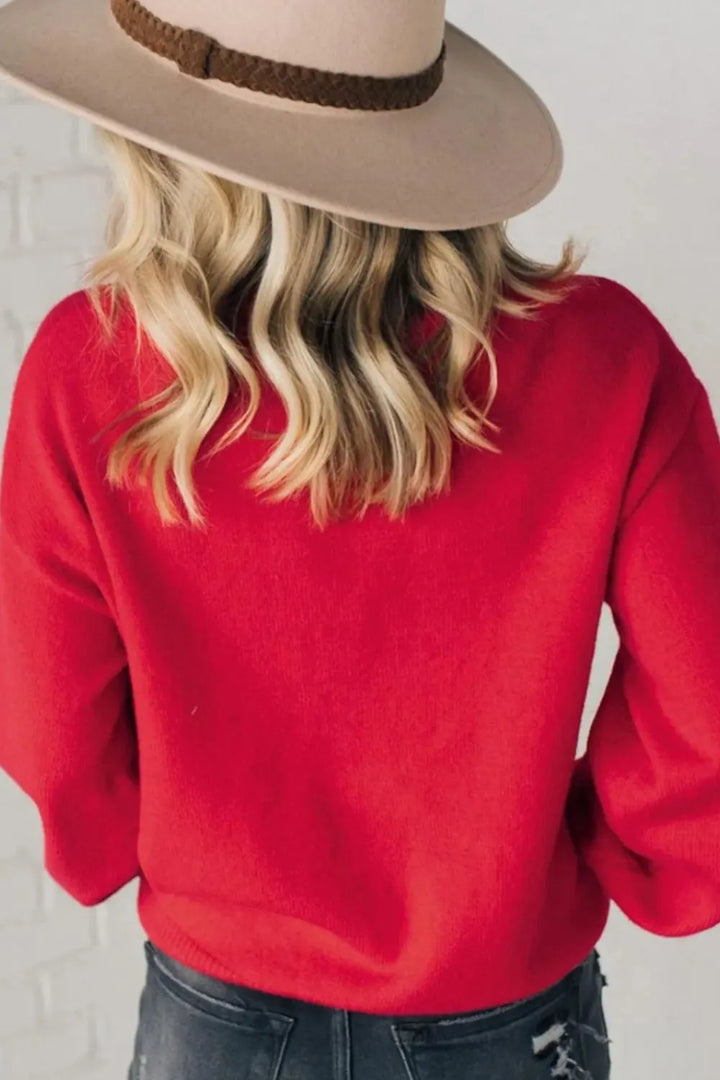 Back view of the red crew neck Christmas sweater with a wide brim hat