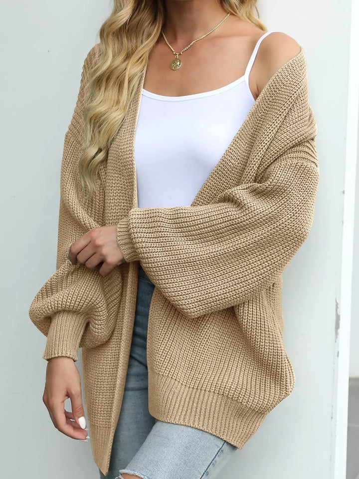 Tan oversized cardigan in a side view with a loose batwing sleeve