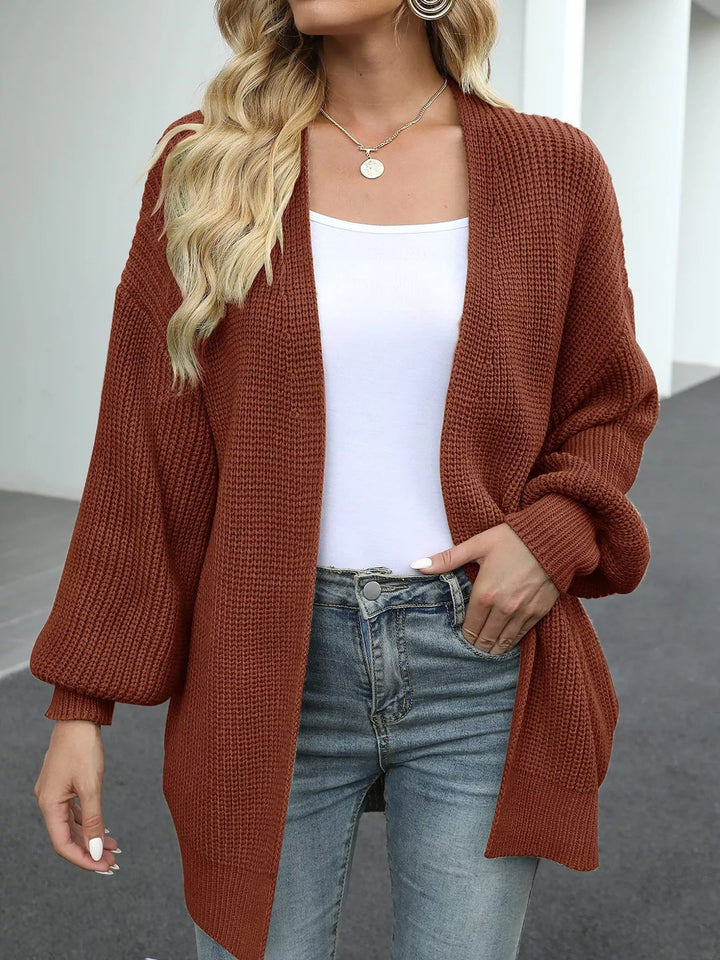 Front view of the rust chunky knit cardigan worn over a white tank and jeans