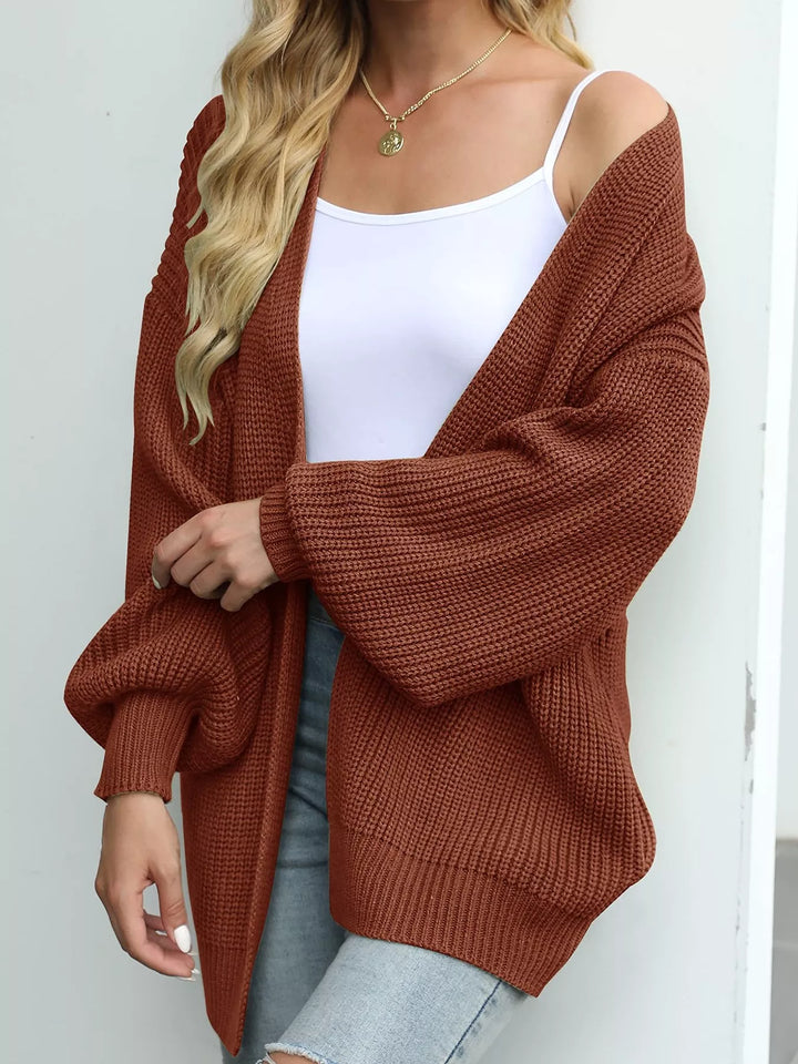 Rust oversized open front cardigan with lantern sleeves, angled view
