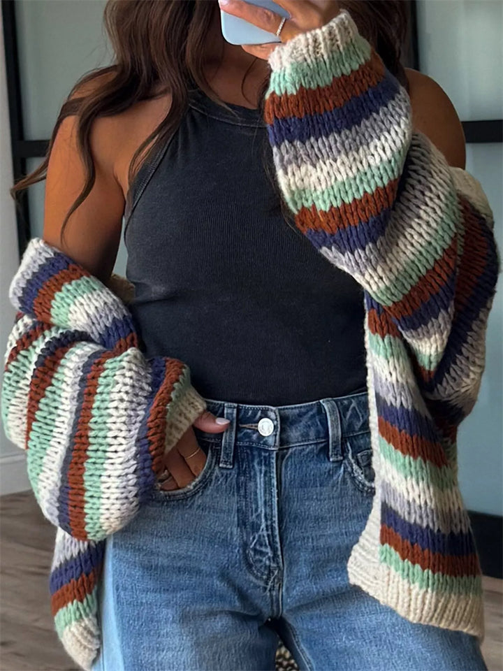 Earth stripe cardigan slipping off the shoulders over a black halter top