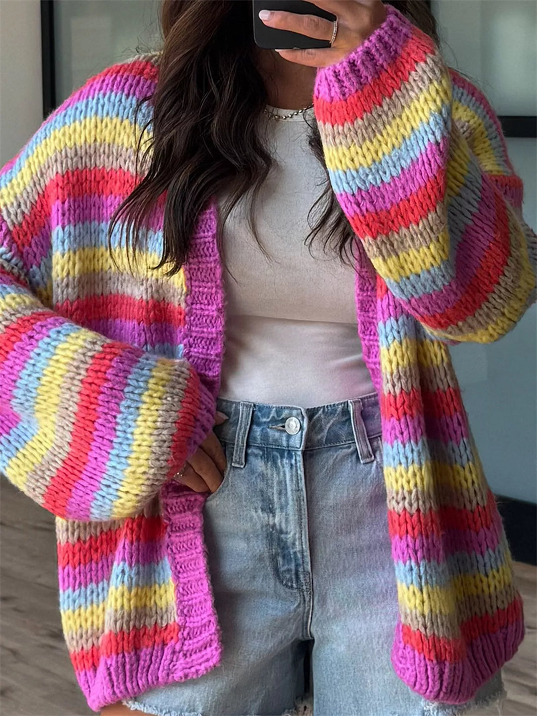 Close-up of the rainbow stripe cardigan with pink ribbed hem and cuff