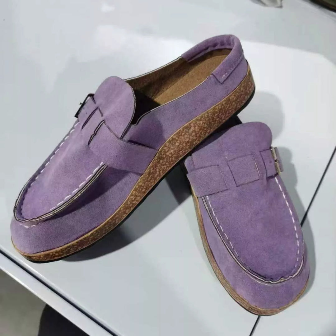 Pair of lilac clogs with buckle strap and cork-look footbed, top angle