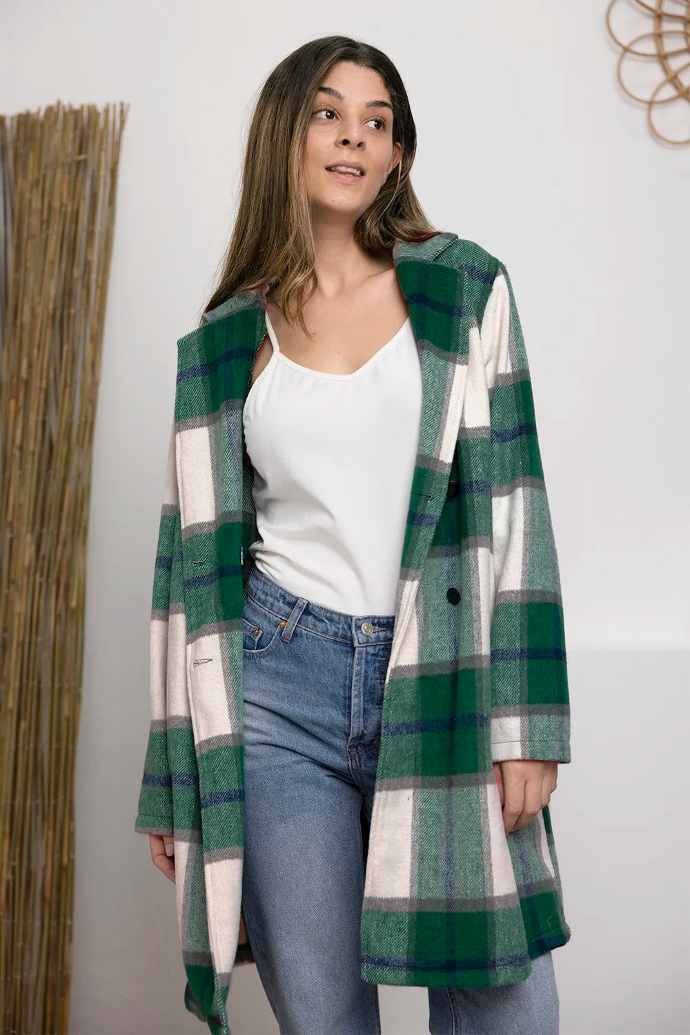 Green plaid coat mid length with notch lapel over a white top and jeans