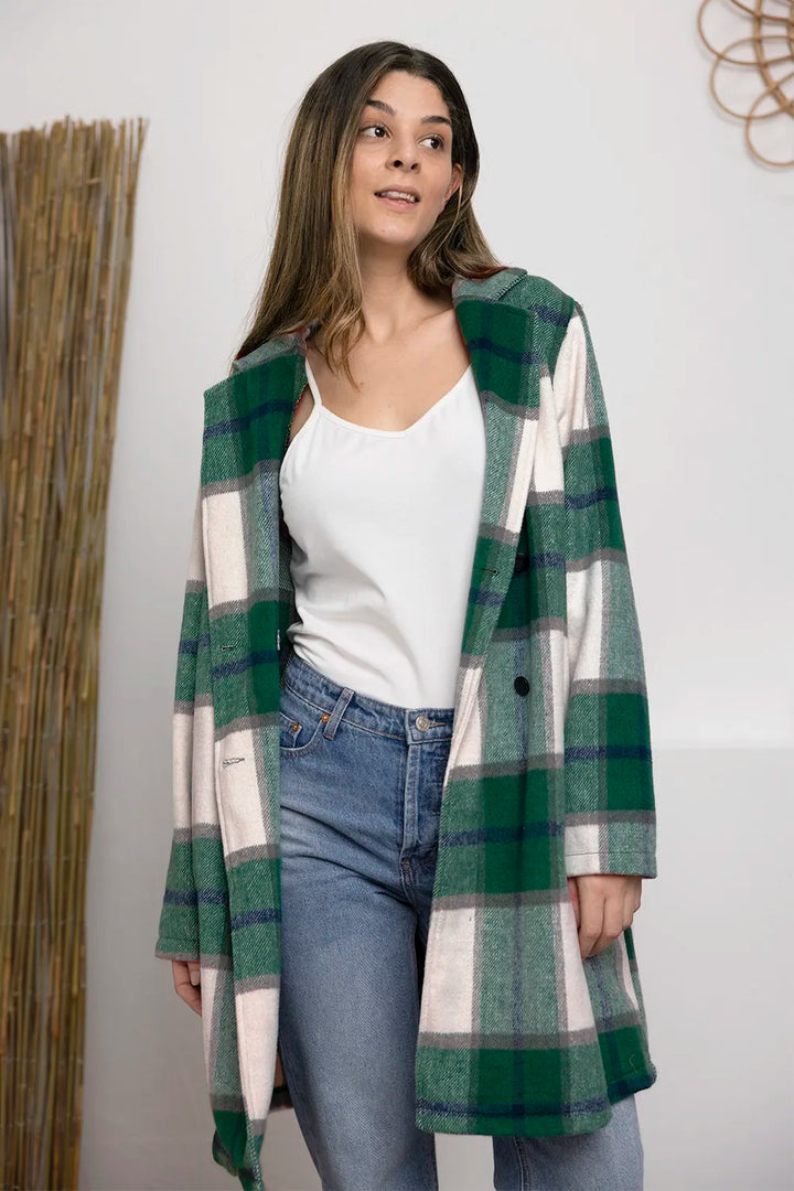 Green plaid coat mid length with notch lapel over a white top and jeans