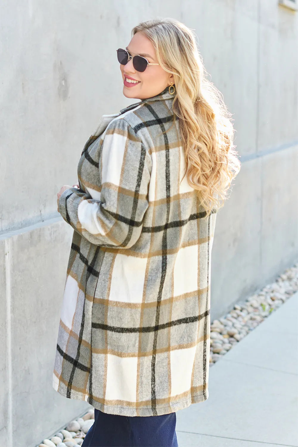 Olive plaid coat turned to the side showing back and sleeve