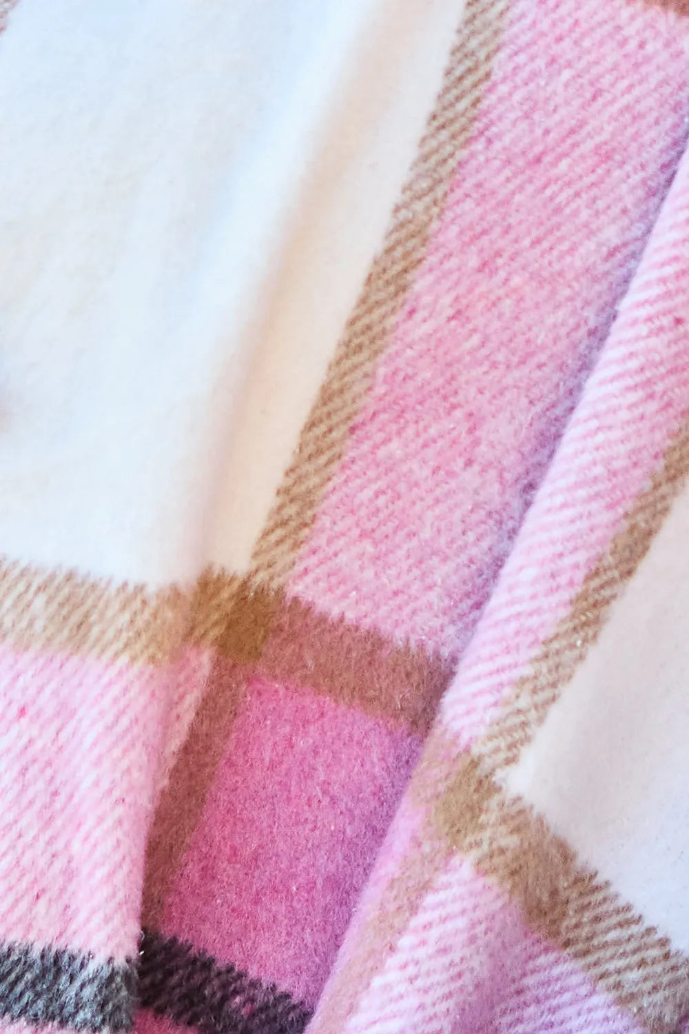Close-up of pink plaid fabric with tan and navy stripes