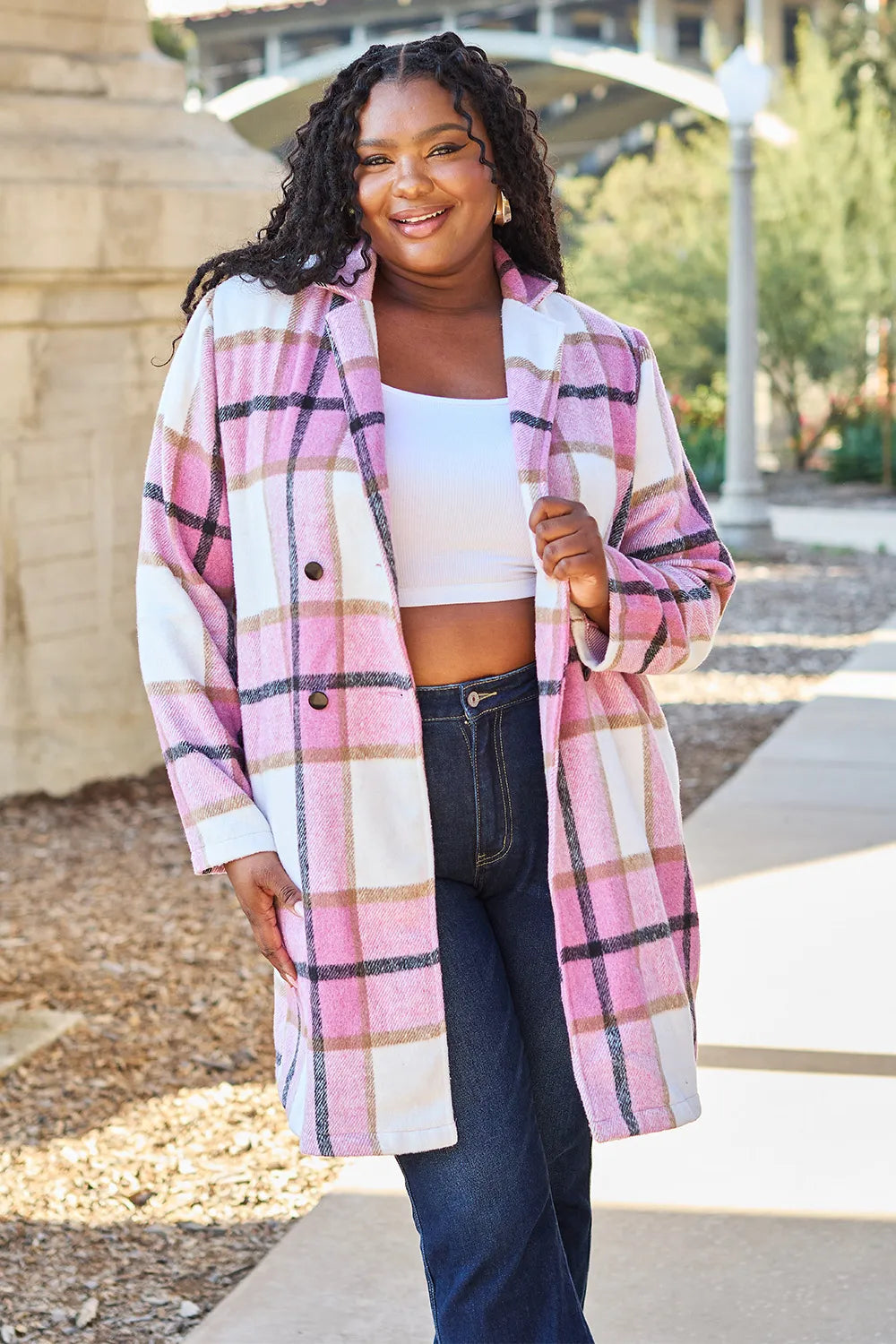 Pink plaid coat with notch lapel styled over a crop top and jeans